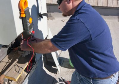 Heald Mechanical technician diagnosing a residential air conditioning system in Sacramento, CA.