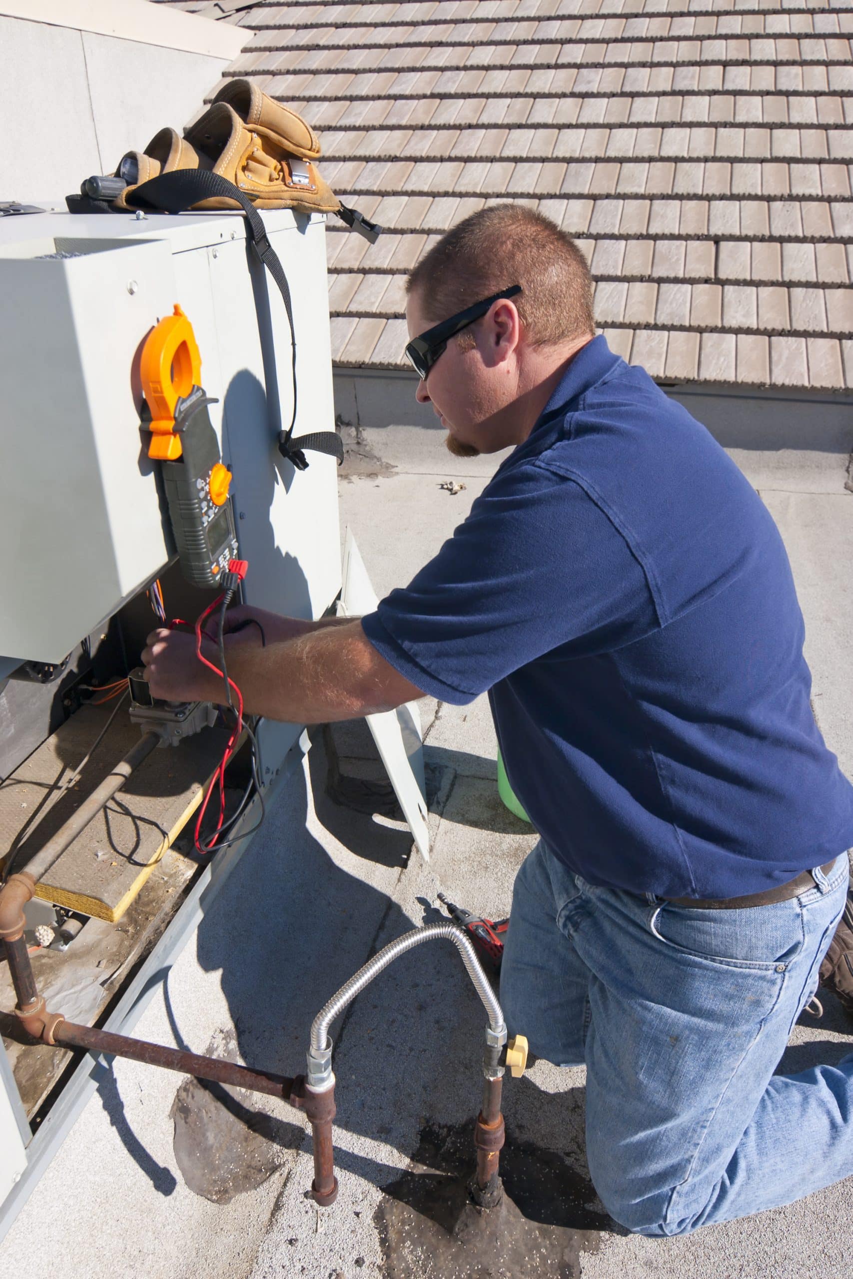 Heald Mechanical technician diagnosing a residential air conditioning system in Sacramento, CA.